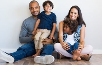 Happy familly sitting on the floor