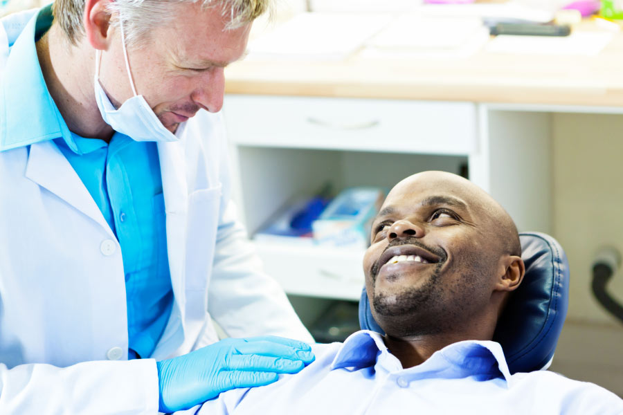 man consults with the dentist before a dental implant restoration