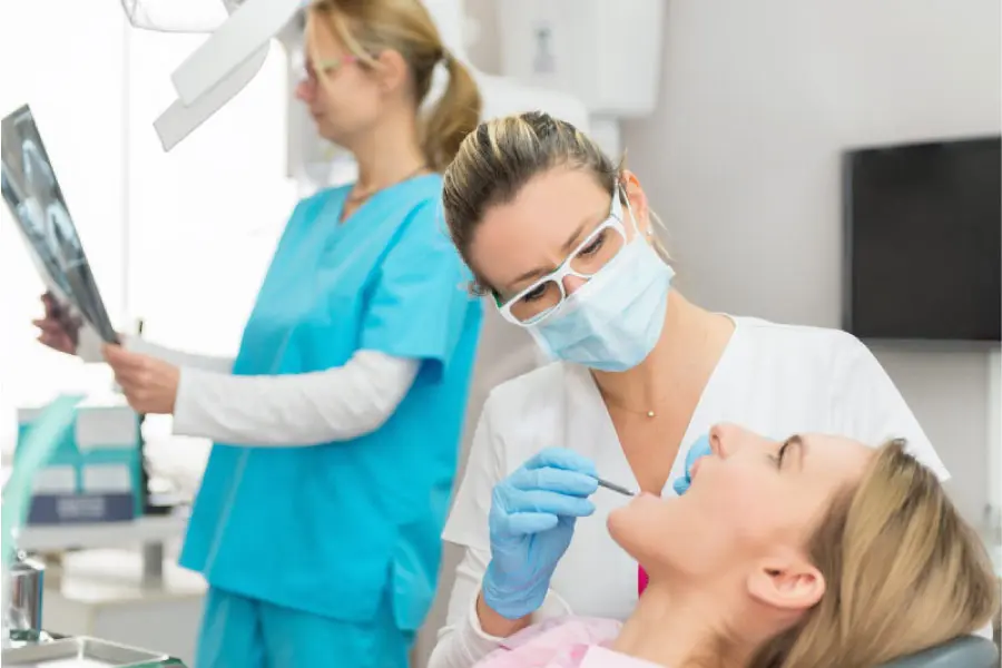 woman in the dentist chair getting a regular exam and cleaning
